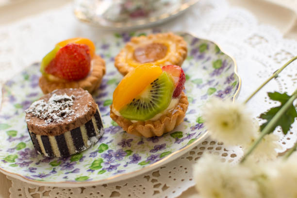 istock Small fruit tarts laid out on an antique china plate 637850486