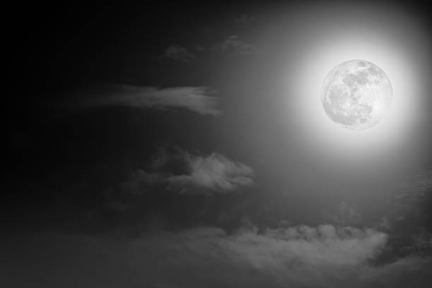 istock Nighttime sky with clouds and bright full moon with shiny. 637851278