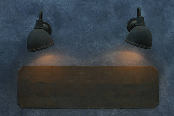 istock wood sign board on wall with lamp of light 637851404