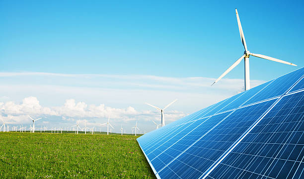 istock solar panel in green lawn with wind power station 637851510