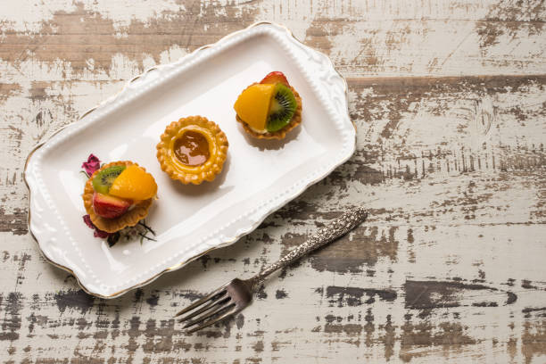 istock Three fruit tarts presented on an elegant antique china plate 637851972