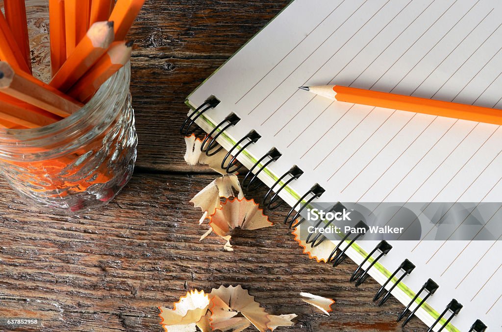 Notebook and Pencils A top view image of an open notebook and several wooden pencils. Lined Paper Stock Photo