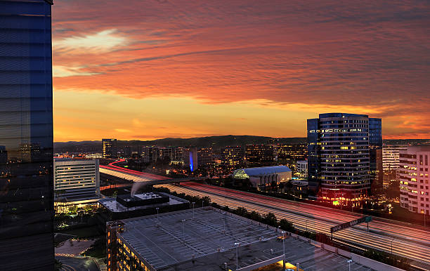 istock Sunrise over light trails and city lights 637853910