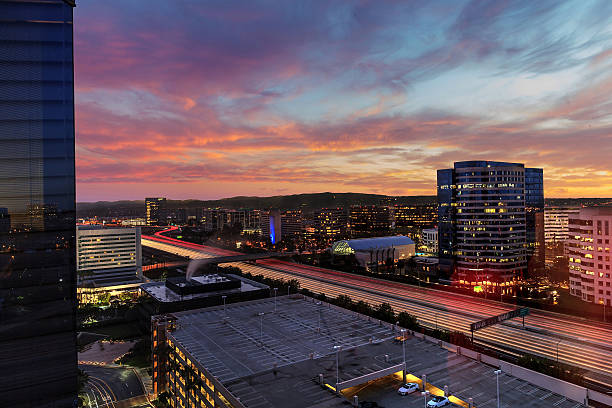 istock Sunrise over light trails and city lights 637853962