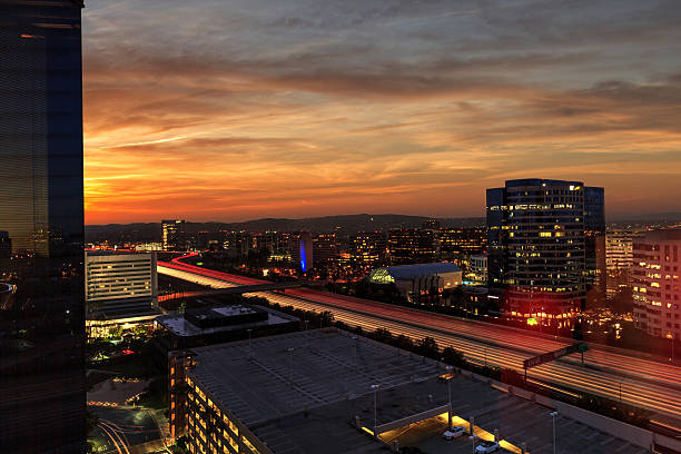 istock Sunrise over light trails and city lights 637853998