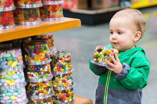 Caucasian Baby Boy shopping for candies in a supermarket