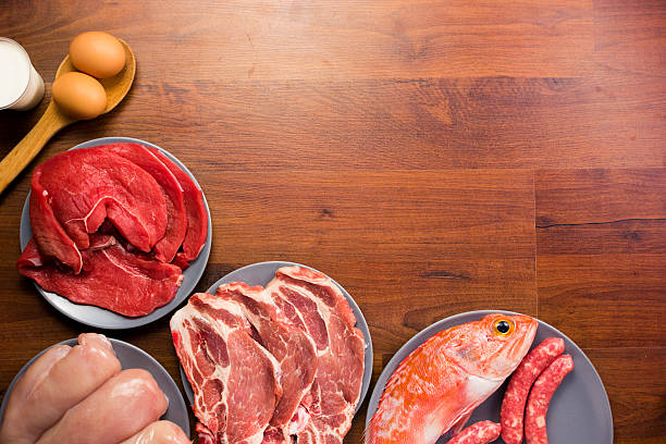 istock Different types of healthy uncooked proteins on a wooden table 637859562