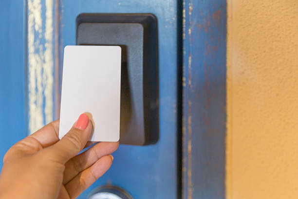 istock Female hands touching key card hotel to cardkey reader 637862224
