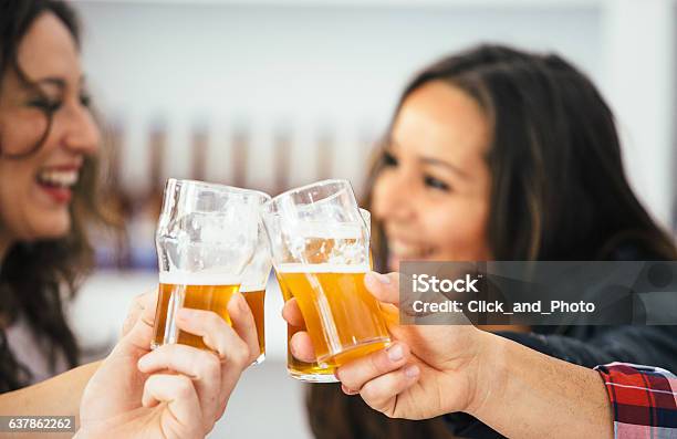 Company Of Four Toasting With Glasses Stock Photo - Download Image Now - Adult, Alcohol - Drink, Artisanal Food and Drink
