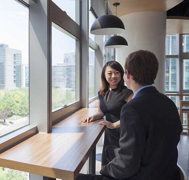 istock Colleagues talking in office break room area 637864048