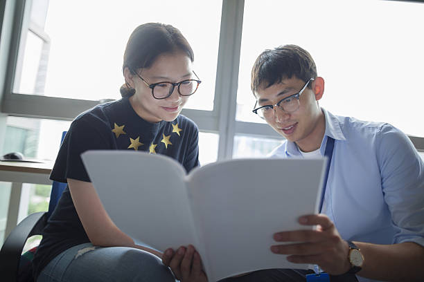 istock Education consultant with Chinese students in office 637864546