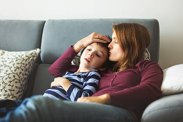 istock Young mother, holding her little sick boy 637865154