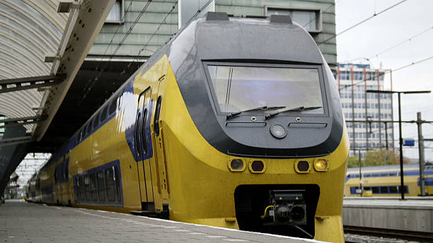 istock Amsterdam, the Netherlands. Yellow train leaving railway station 637865838