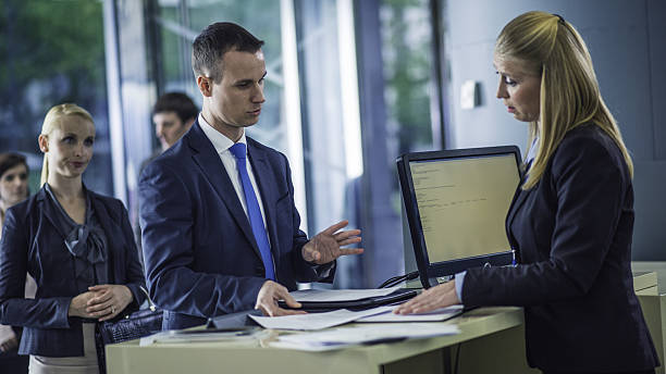 man asking questions at a bank counter - bank bank teller customer banking imagens e fotografias de stock