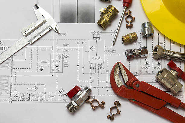 istock Office desk with hydraulic fittings, helmet  and project design 637866664