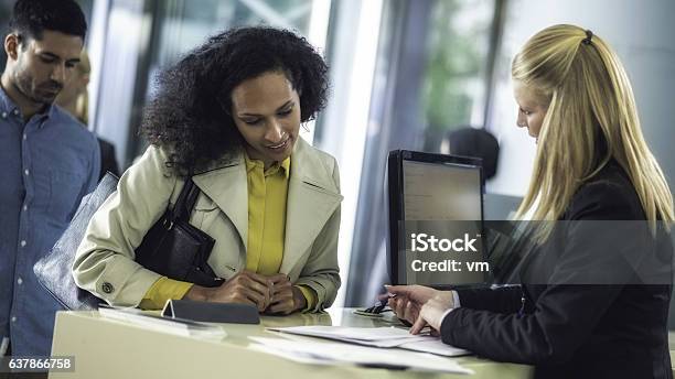 Bank Teller Explaining Loan Details To Customer Stock Photo - Download Image Now - Bank Teller, 30-39 Years, Adult