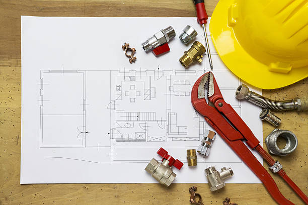 istock Office desk with hydraulic fittings, helmet  and project design 637866778
