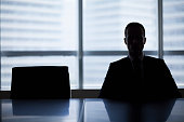 Silhouette of businessman in office meeting room