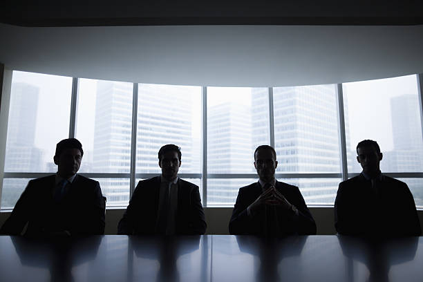 silhouette row of businessmen sitting in meeting room - shadow focus on shadow people men imagens e fotografias de stock