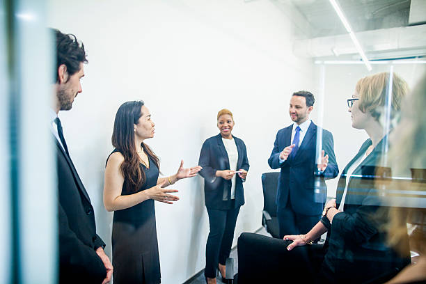 Group of colleagues having business meeting in office Group of colleagues having business meeting in office corporate hierarchy stock pictures, royalty-free photos & images