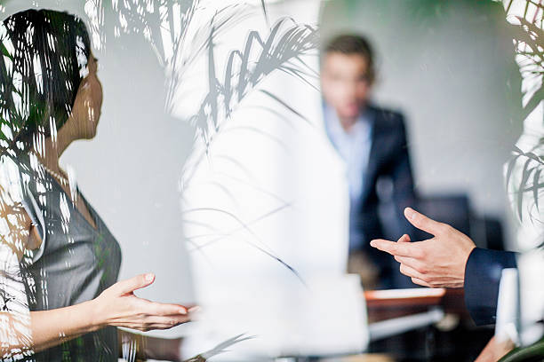 Business colleagues talking in office meeting