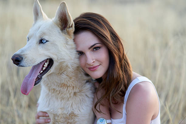 Portrait of beautiful blonde girl with a dog