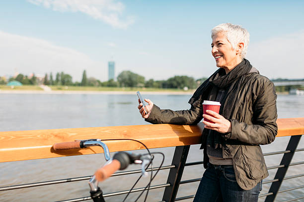 istock Mature Woman Texting On The Phone And Drinking Coffee. 637870042