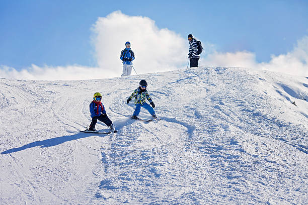 istock Two young children, siblings brothers, skiing in Austrian mounta 637870074