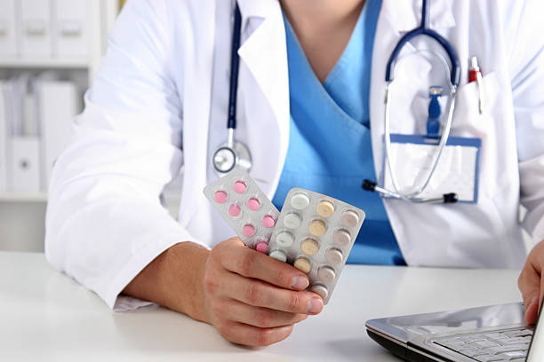 istock Hand of doctors holding many different pills 637872654