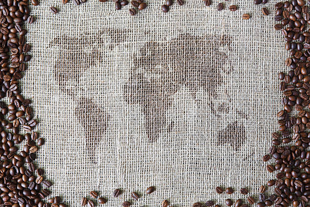 istock Burlap texture with coffee beans border and world map 637873928