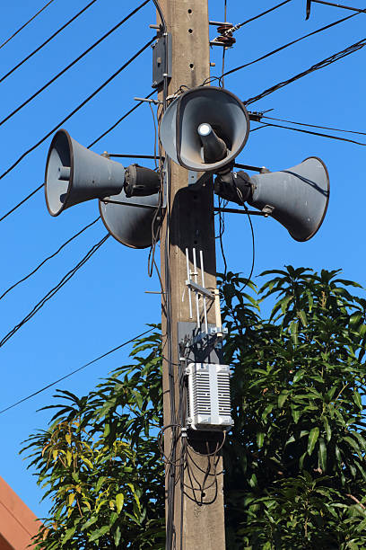 istock Loudspeakers broadcast wirelessly installed on electric poles. 637873974