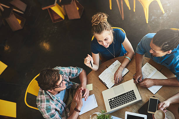 We have everything we need to pass High angle shot of a group of students studying in a coffee shop college stock pictures, royalty-free photos & images