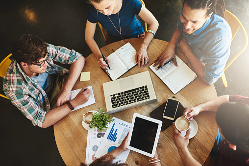 High angle shot of a group of students studying in a coffee shop