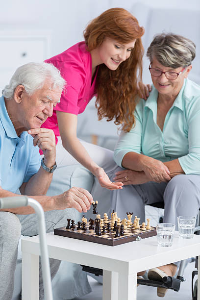 istock Couple playing chess in nursing home 637874668