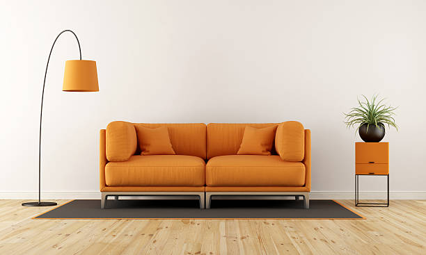 Modern living room with orange couch Modern living room with white wall, orange couch and floor lamp - 3d rendering sofa stock pictures, royalty-free photos & images