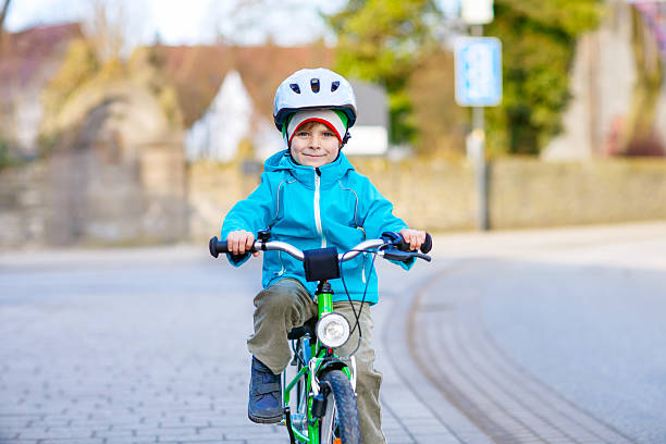 istock Little preschool kid boy riding on bicycle 637879848
