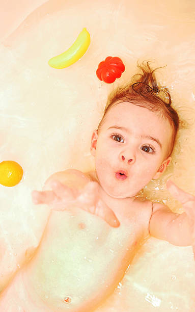 istock Cute baby girl taking a bath 637880090