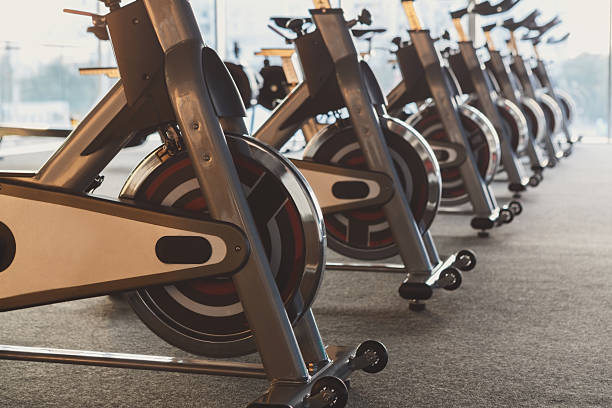 istock Modern gym interior with equipment, fitness exercise bikes 637881070