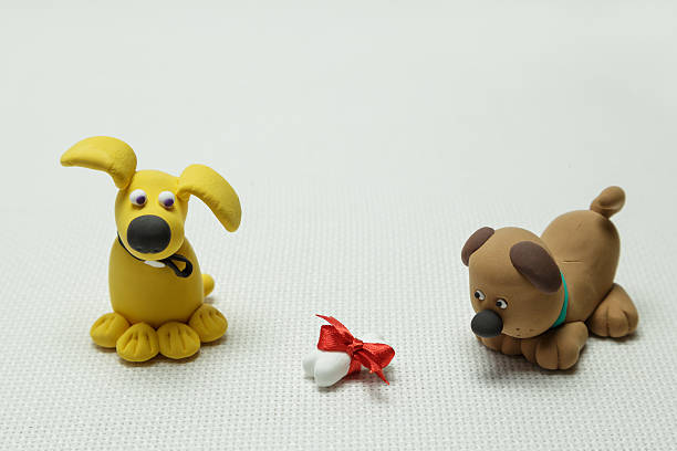 istock Two dogs and a bone tied up by a band 637883468