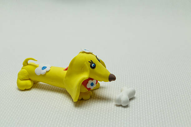 istock Toy a dog from plasticine and a bone 637883532