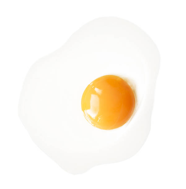 Fried egg isolated on white background. Fried chicken egg isolated on white background. Classic protein rich breakfast top view egg yolk on white stock pictures, royalty-free photos & images