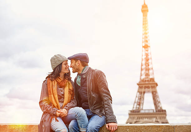 kissing under the shadow of the eiffel tower - paris france eiffel tower love kissing imagens e fotografias de stock