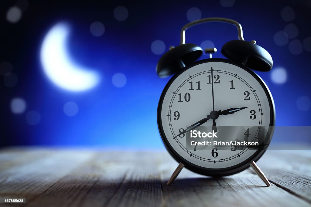 Alarm clock in the middle of the night insomnia Alarm clock in the middle of the night insomnia or dreaming Sleeping Stock Photo
