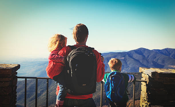 istock father with two kids travel in mountains 637885644