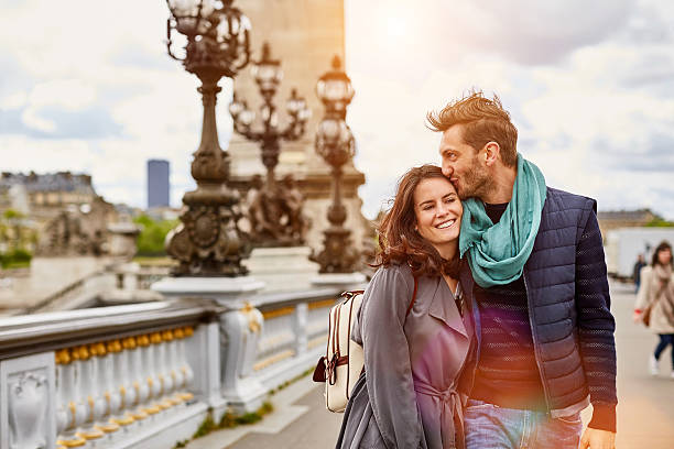 Arm in arm in Paris Shot of a smiling young couple walking together in the streets of Paris romantic activity stock pictures, royalty-free photos & images