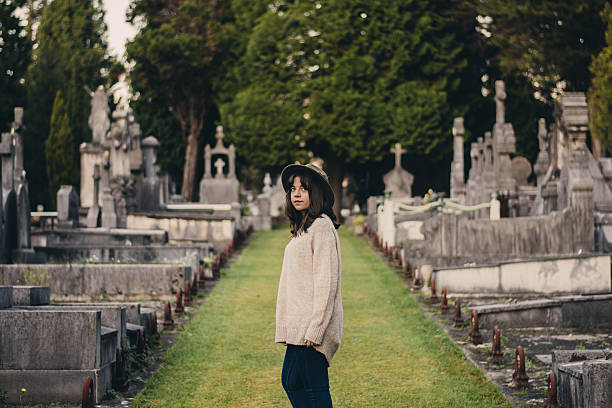 istock Young Woman at Cemetery 637887294