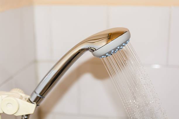 istock Close up of a shower head with sprinkling water 637888002