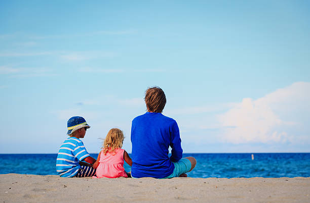 istock father with little son and daughter on tropical beach 637888028