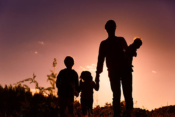 istock father with tree kids walk in sunset nature 637888322