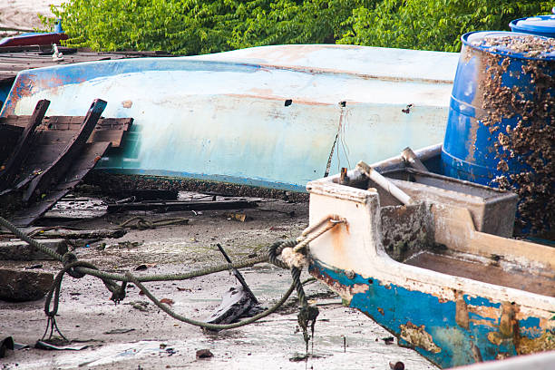 istock Broken abandoned fishing boat by the shore 637890462